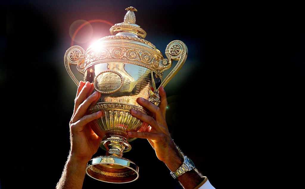 Roger Federer holds aloft the Wimbledon Mens Singles Trophy.
